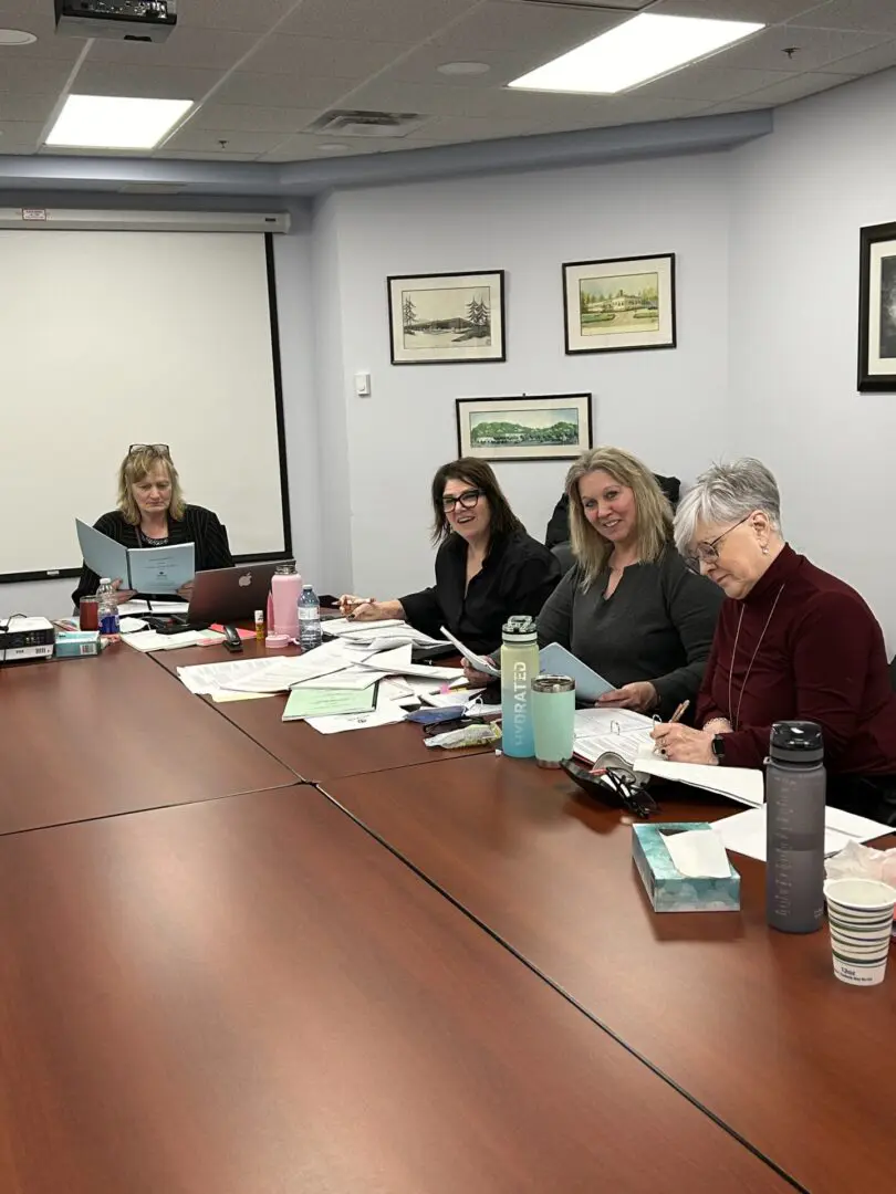 a group of people sitting at a boardroom